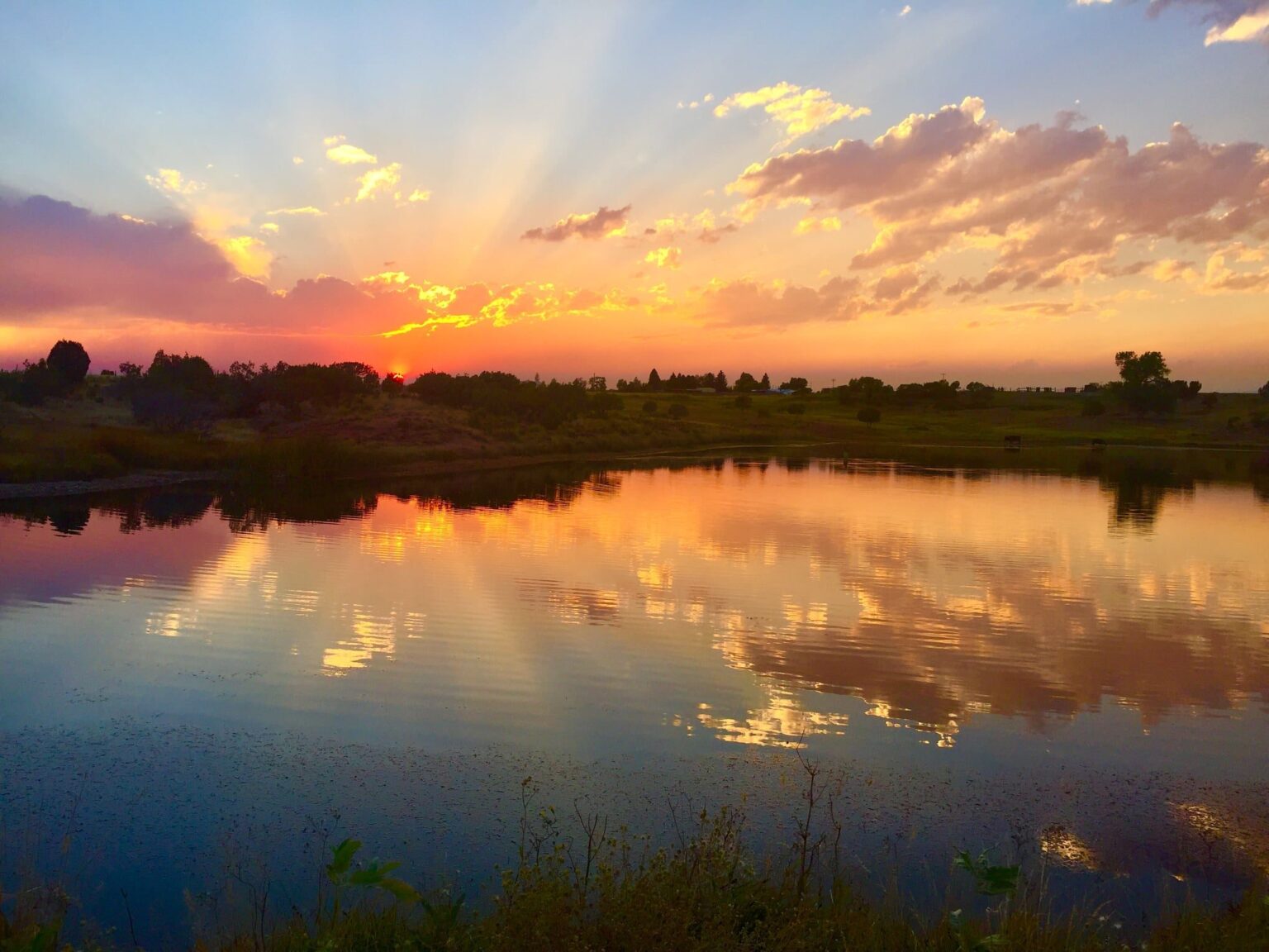 Sunset reflected on a lake at Six Lakes Resort